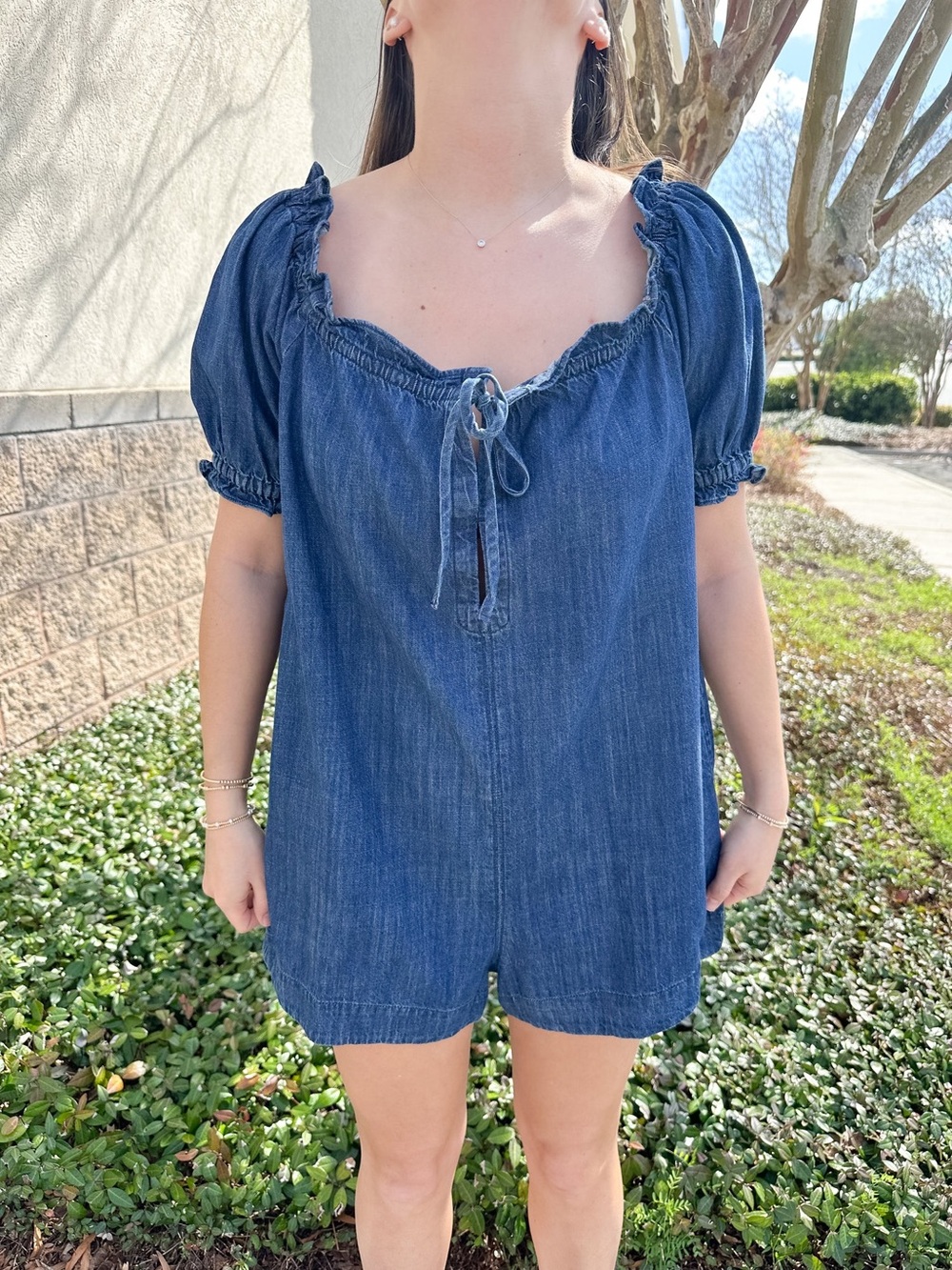 OLIVACEOUS RUFFLED EDGE WASHED DENIM ROMPER